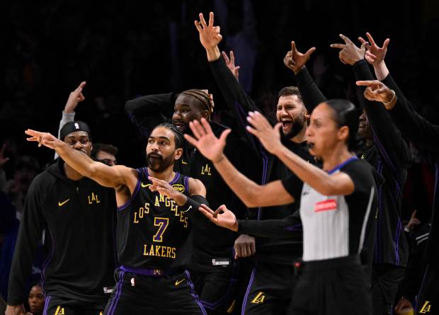 Lakers guard Gabe Vincent (7) gestures after making a 3-point...