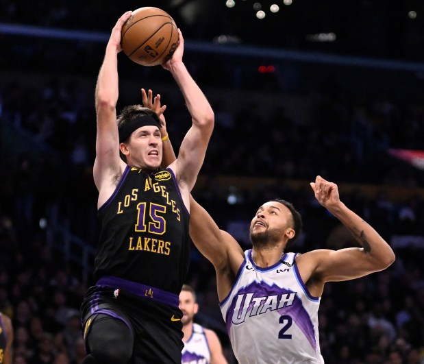 Lakers guard Austin Reaves grabs a rebound over the Utah...