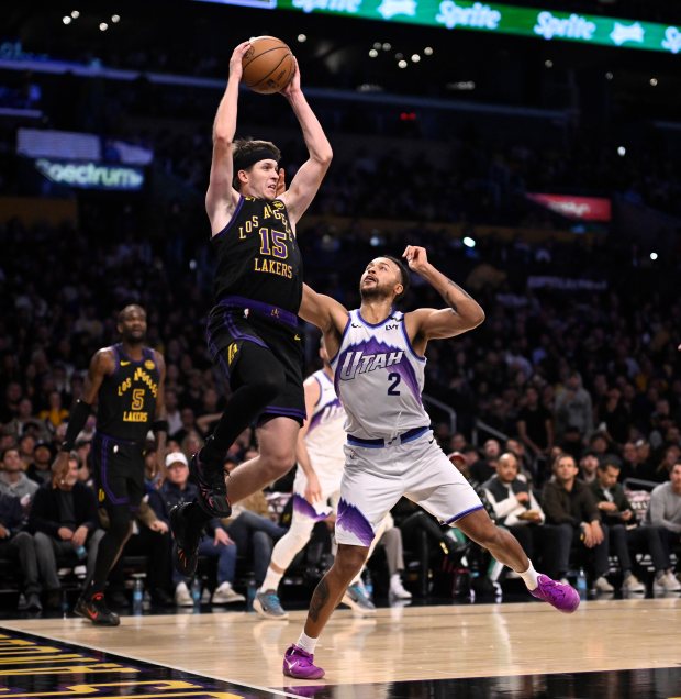 Lakers guard Austin Reaves grabs a rebound over the Utah...