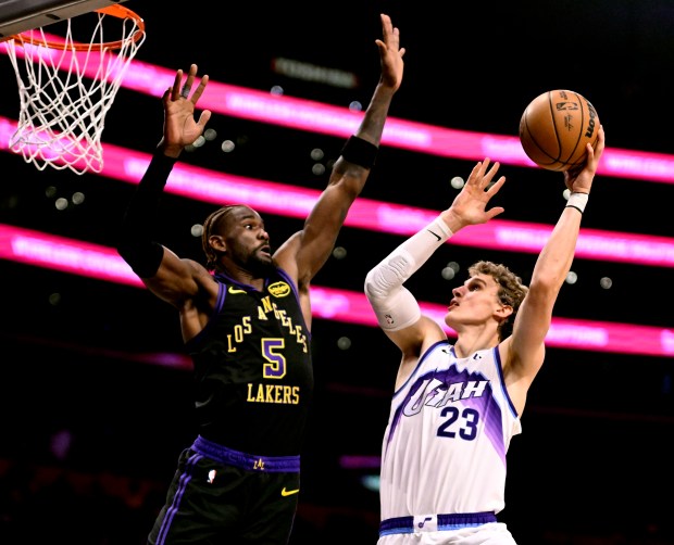 Utah Jazz forward Lauri Markkanen shoots as Lakers center Deandre...