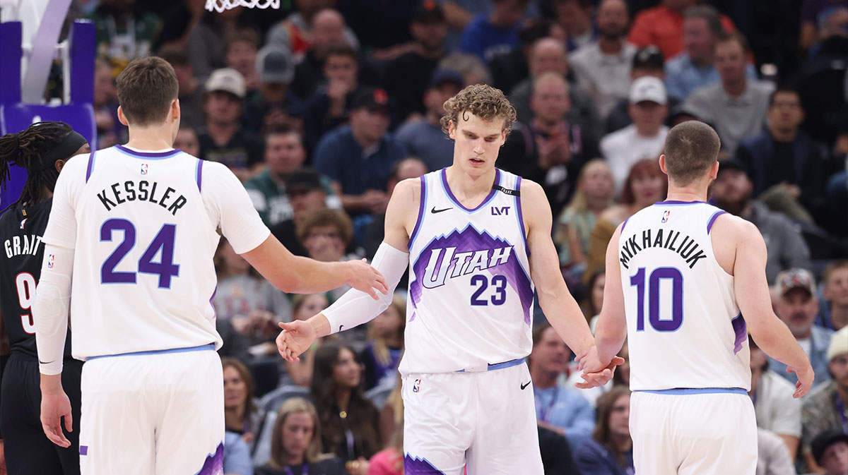 Utah Jazz forward Lauri Markkanen (23) interacts with center Walker Kessler (24) and guard Svi Mykhailiuk (10) after a basket against the Portland Trail Blazers during the second quarter at Delta Center.
