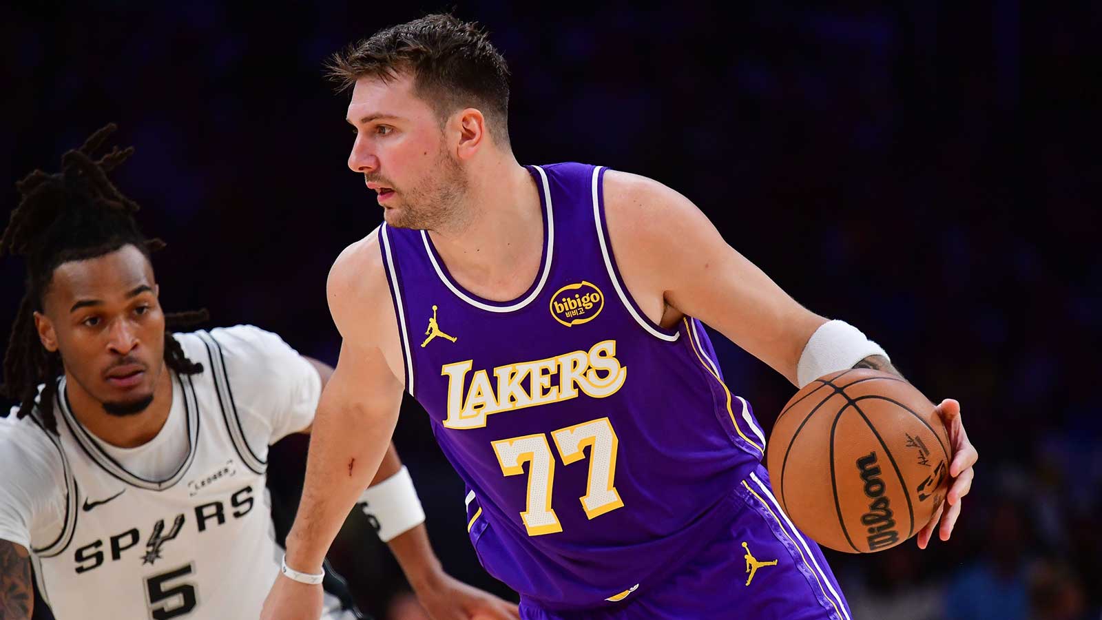 Los Angeles Lakers guard Luka Doncic (77) moves the ball against San Antonio Spurs guard Stephon Castle (5) during the first half at Crypto.com Arena.