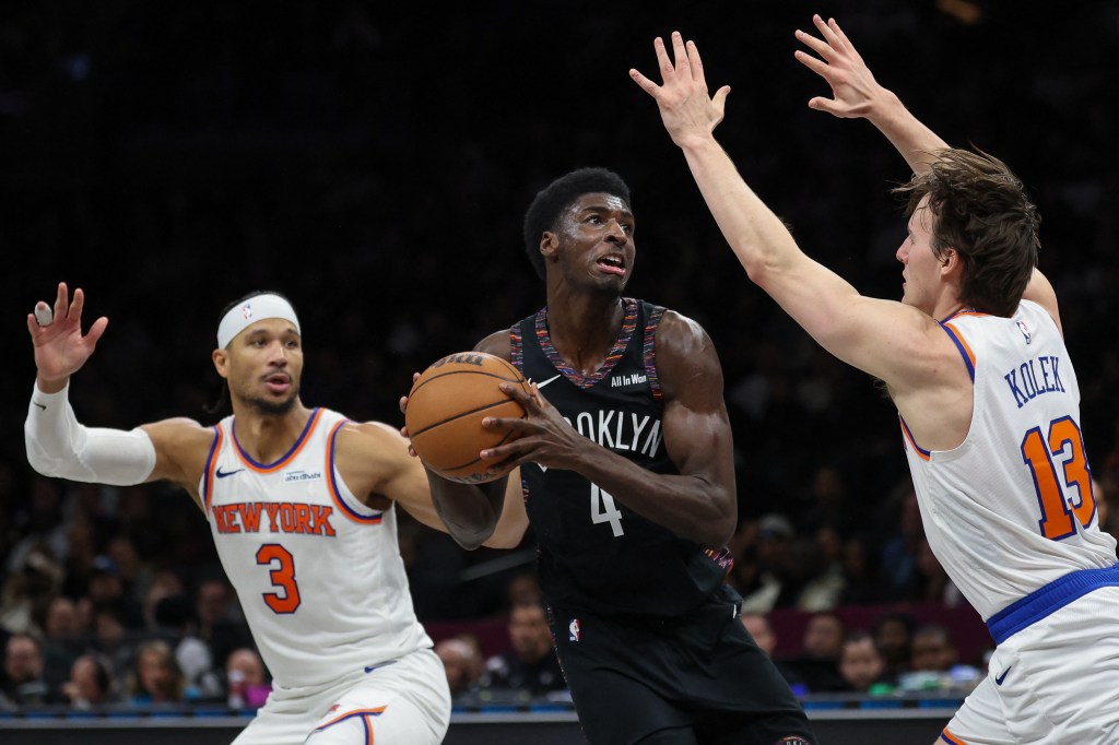 Nets guard Drake Powell (4) is guarded by New York Knicks guard Josh Hart (3) and guard Tyler Kolek (13)