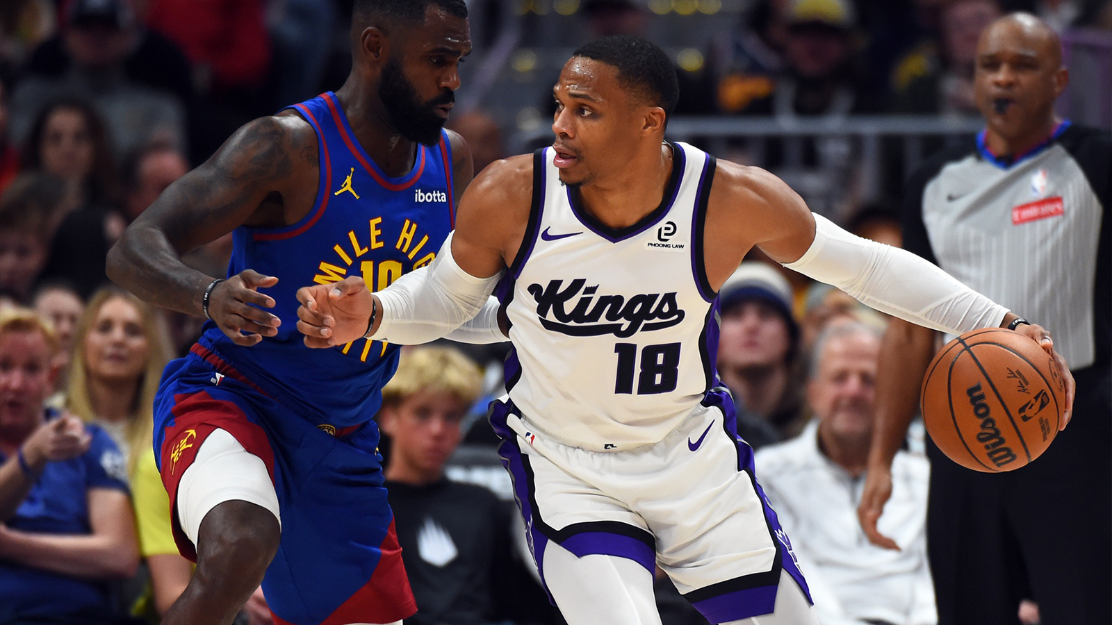 Sacramento Kings guard Russell Westbrook (18) handles the ball against Denver Nuggets guard Tim Hardaway Jr. (10) during the first half at Ball Arena.