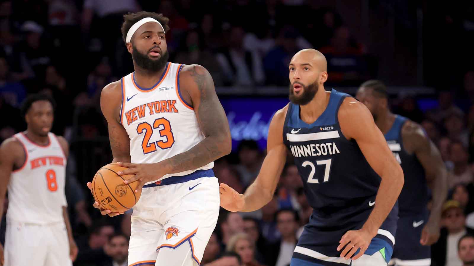Nov 5, 2025; New York, New York, USA; New York Knicks center Mitchell Robinson (23) controls the ball against Minnesota Timberwolves center Rudy Gobert (27) during the second quarter at Madison Square Garden. Mandatory Credit: Brad Penner-Imagn Images