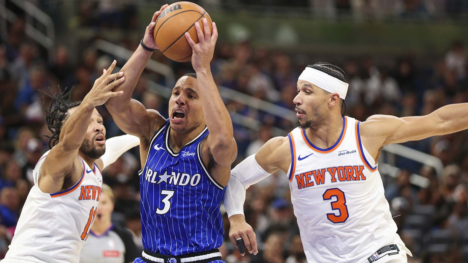 Orlando Magic guard Desmond Bane (3) drives to the basket past New York Knicks guard Jalen Brunson (11) and guard Josh Hart (3) in the fourth quarter at Kia Center.