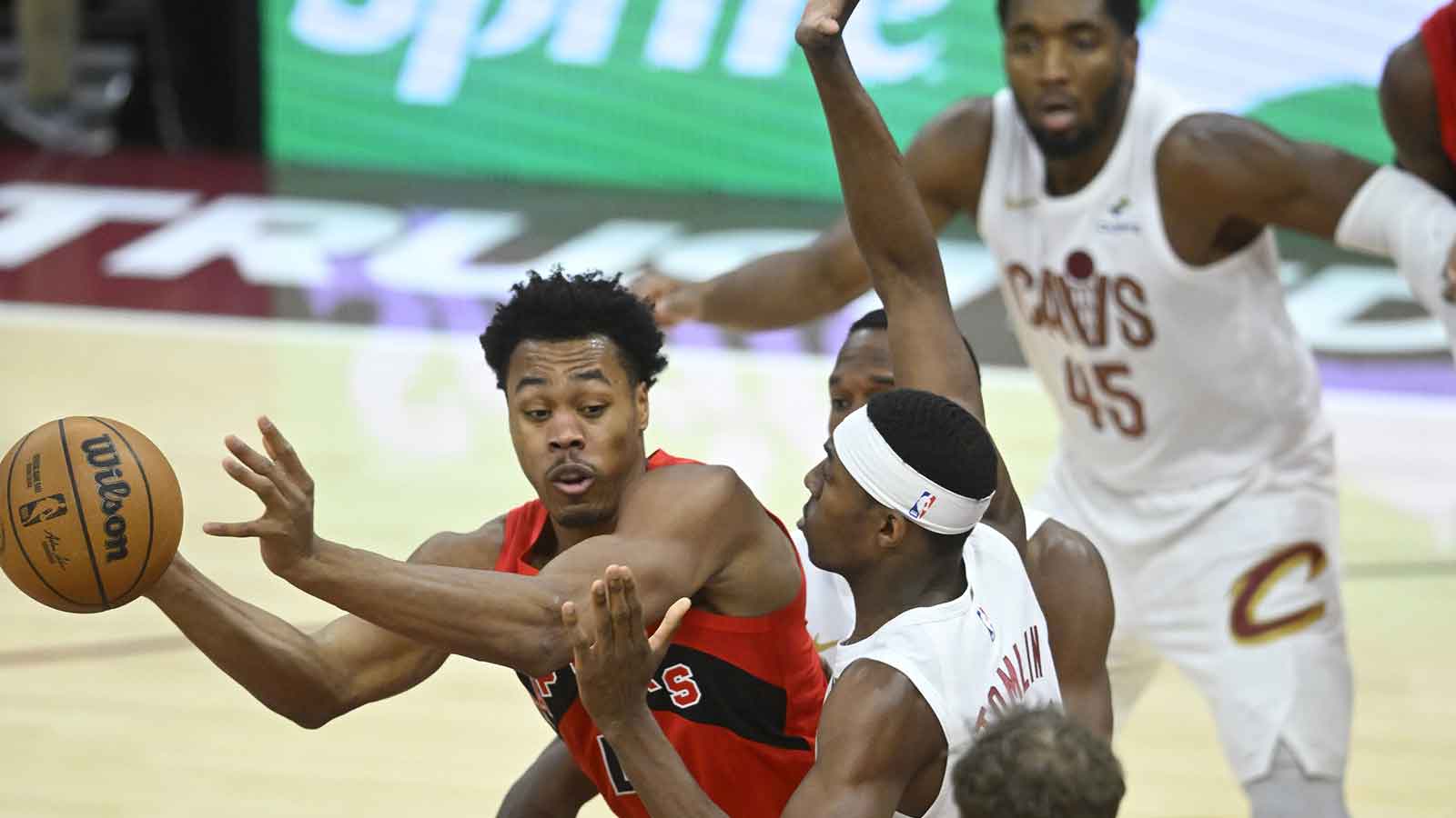 Toronto Raptors forward Scottie Barnes (4) looks to pass beside Cleveland Cavaliers forward Nae'Qwan Tomlin (35) in the fourth quarter at Rocket Arena. 