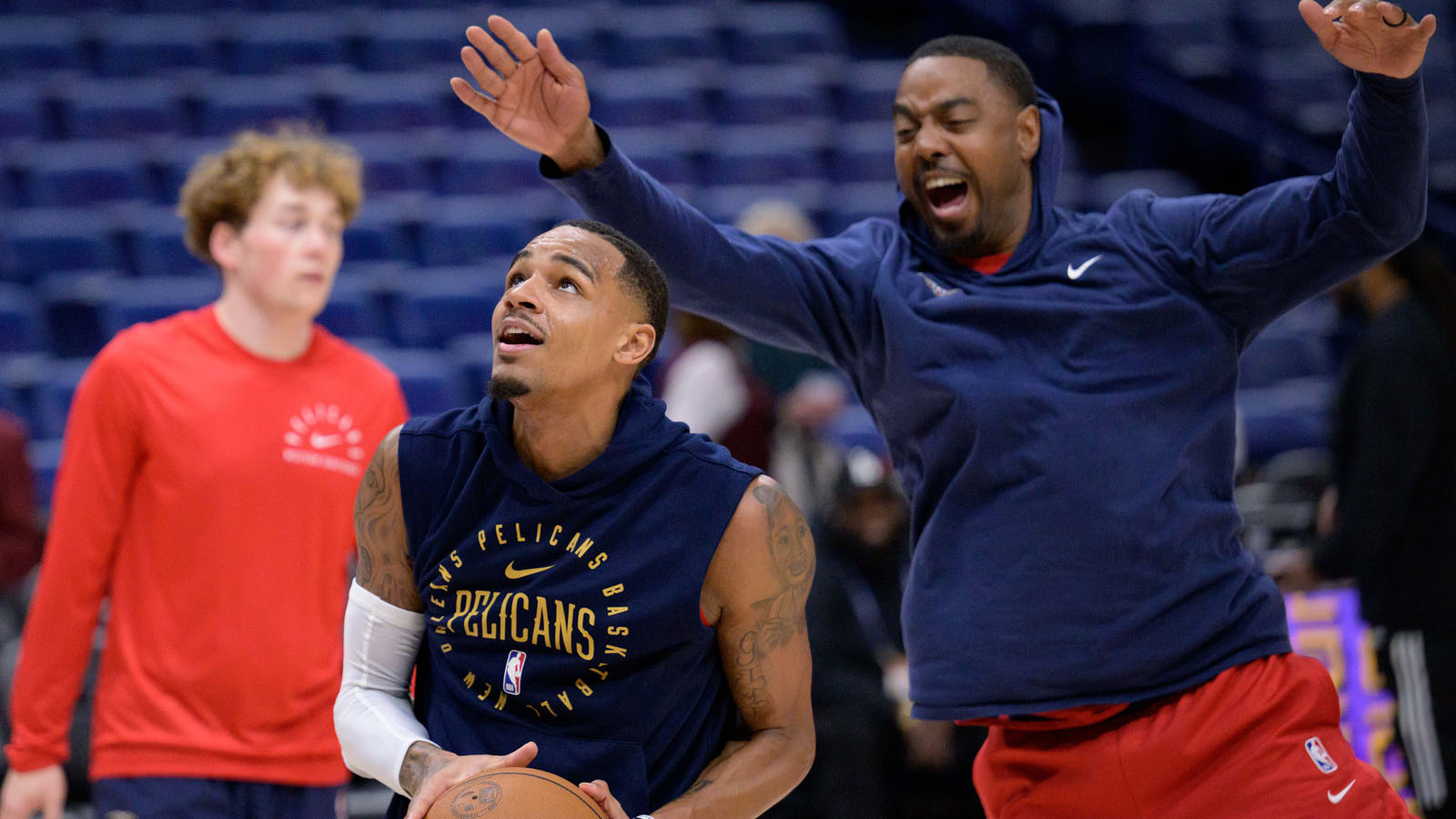 Pelicans guard Dejounte Murray warms up with a trainer before a game against the Dallas Mavericks at Smoothie King Center