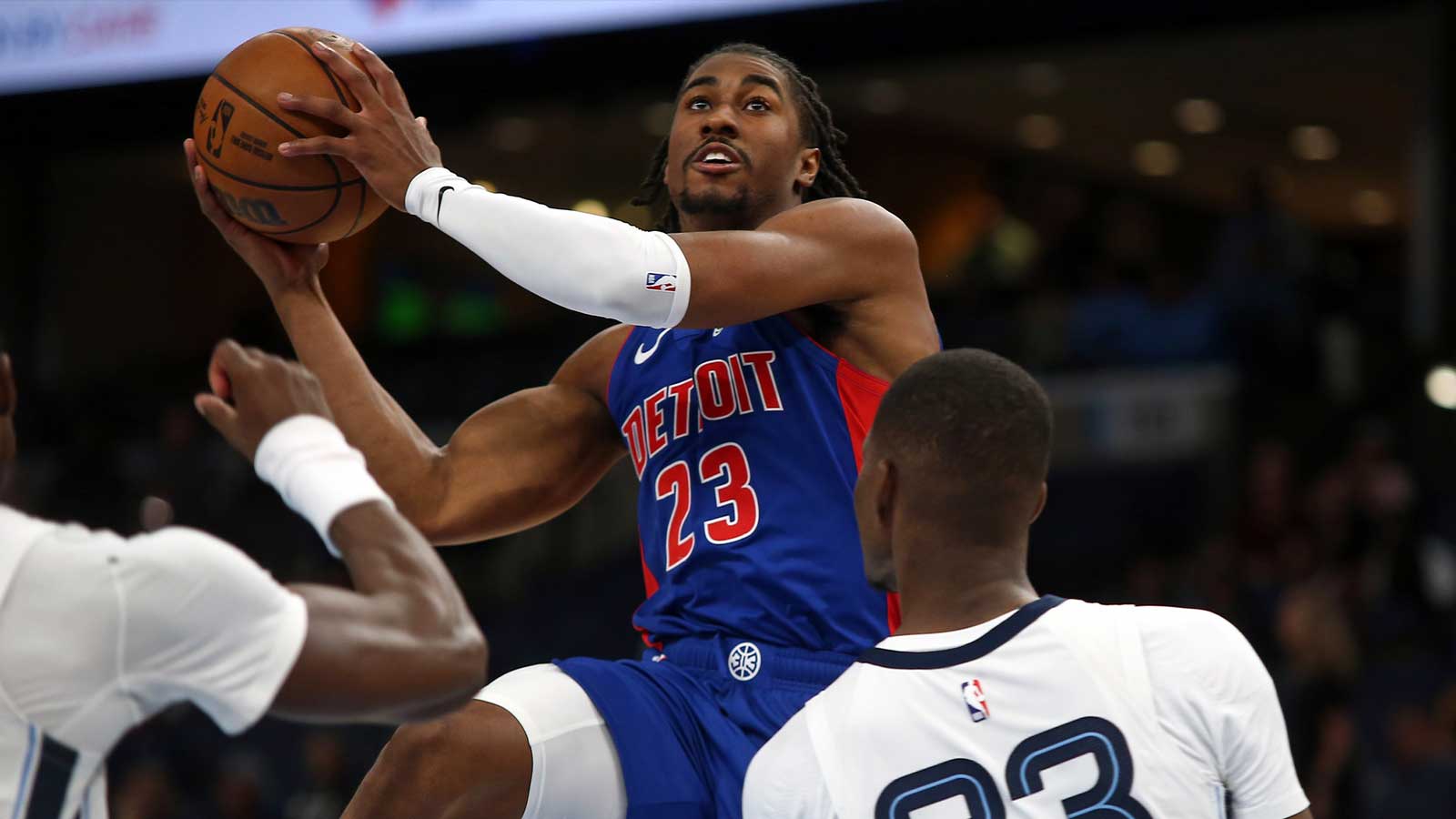 Detroit Pistons guard Jaden Ivey (23) drives to the basket as Memphis Grizzlies forward Cedric Coward (23) defends during the second quarter at FedExForum.