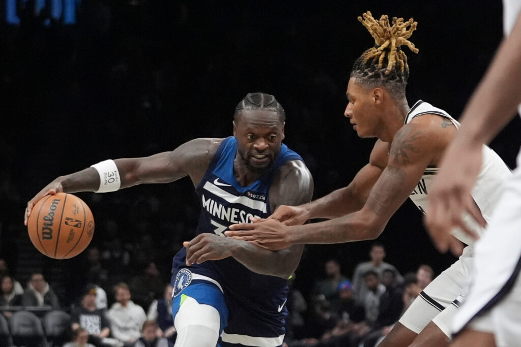 Brooklyn Nets' Noah Clowney, right, defends Minnesota Timberwolves' Julius Randle during the second half of an NBA basketball game Monday, Nov. 3, 2025, at Barclays Center in New York. (AP Photo/Frank Franklin II)