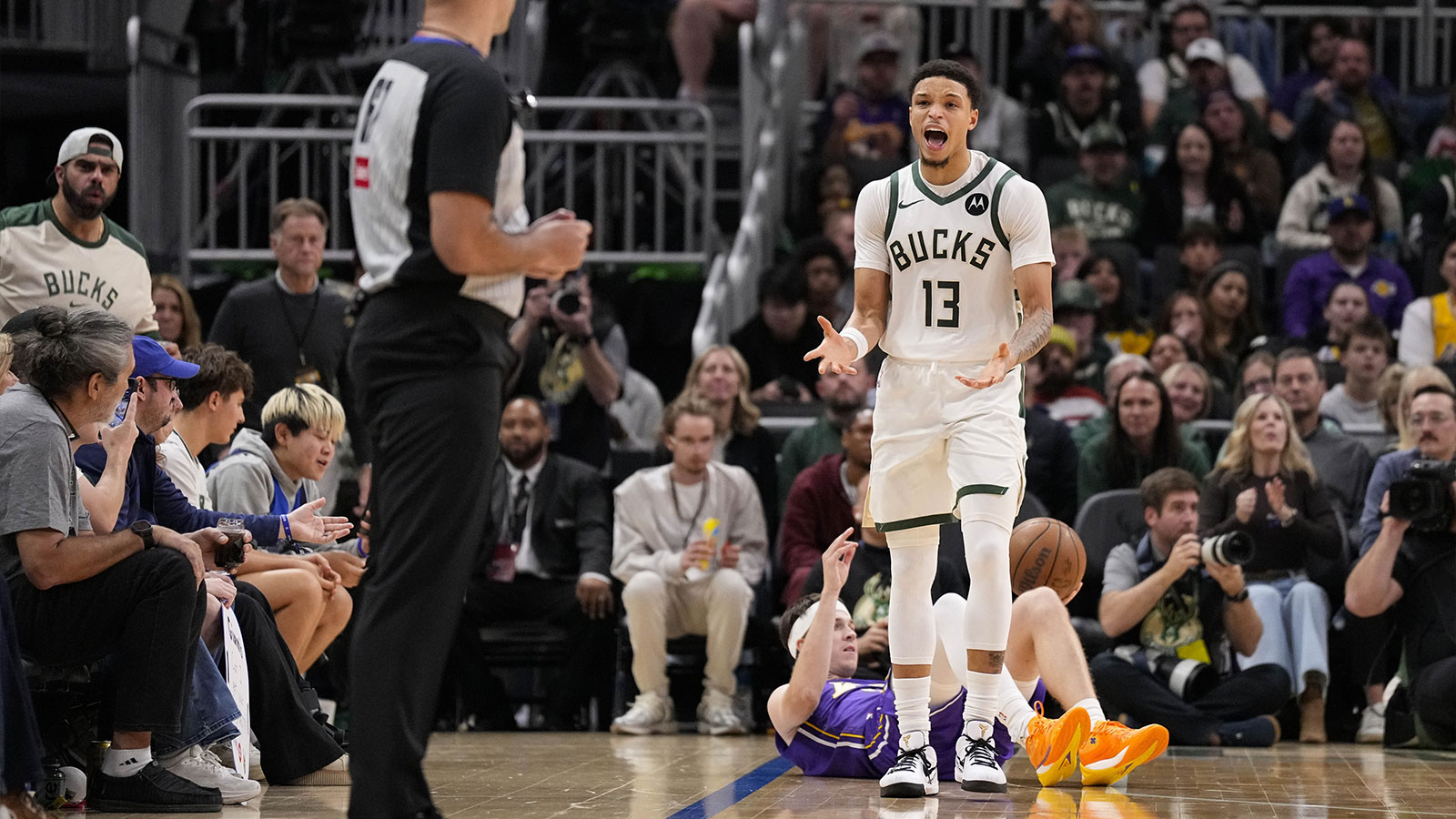 Milwaukee Bucks guard Ryan Rollins (13) reacts after being called for a foul during the third quarter against the Los Angeles Lakers at Fiserv Forum. 
