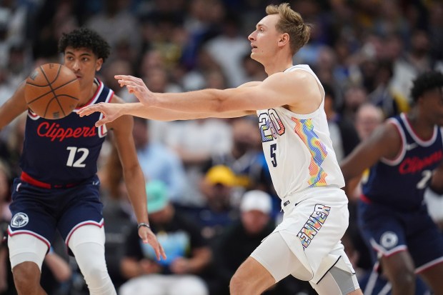 Denver Nuggets forward Hunter Tyson (5) and Los Angeles Clippers guard Cam Christie (12) in the second half of Game 5 of an NBA basketball playoff series Tuesday, April 29, 2025, in Denver. (AP Photo/David Zalubowski)