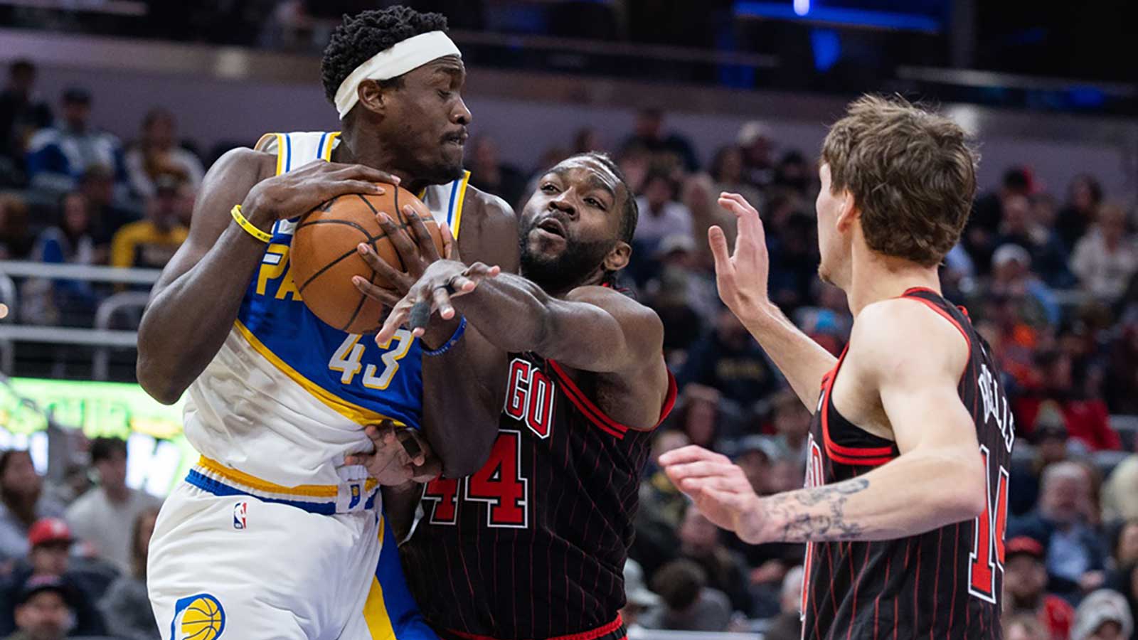 Indiana Pacers forward Pascal Siakam (43) rebounds the ball against Chicago Bulls forwards Patrick Williams (44) and Matas Buzelis (14) during the first half at Gainbridge Fieldhouse.