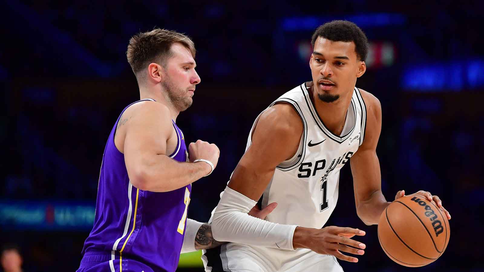 Spurs forward Victor Wembanyama (1) moves the ball against Los Angeles Lakers guard Luka Doncic (77) during the second half at Crypto.com Arena