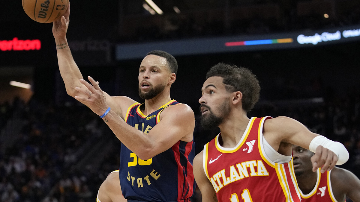 Warriors guard Stephen Curry (30) passes the basketball against Atlanta Hawks guard Trae Young (11)