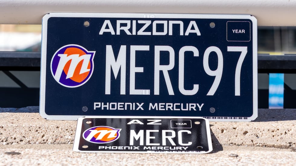 The new Phoenix Mercury license plate design features a black background and white lettering,...
