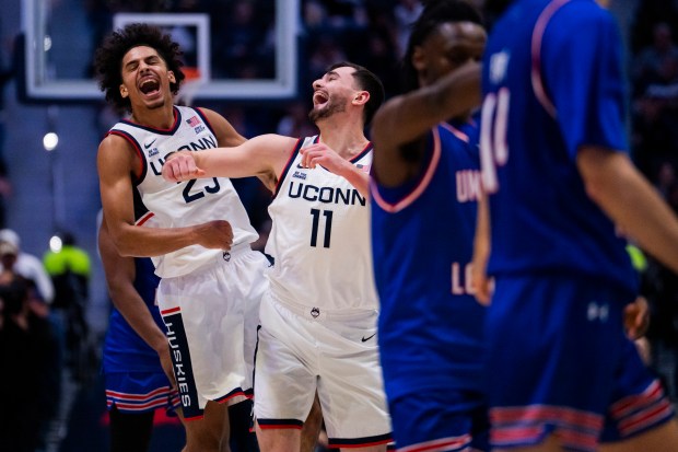 Jayden Ross #23 and Alex Karaban #11 of the Connecticut Huskies react during the first half of an NCAA men's basketball game against the UMass Lowell River Hawks at PeoplesBank Arena on Nov. 07, 2025 in Hartford, Connecticut. (Photo by Joe Buglewicz/Getty Images)