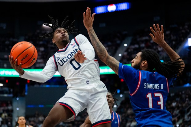 Malachi Smith #0 of the Connecticut Huskies shoots against Shawn Simmons II #13 of the UMass Lowell River Hawks during the first half of an NCAA men's basketball game at PeoplesBank Arena on Nov. 07, 2025 in Hartford, Connecticut. (Photo by Joe Buglewicz/Getty Images)