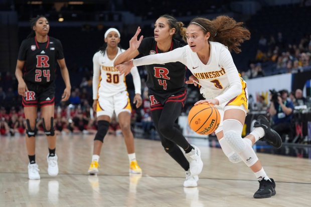 Abbie Parr -- THE ASSOCIATED PRESS Gophers guard Amaya Battle drives against Rutgers guard Antonia Bates during the second half Wednesday night at Target Center.