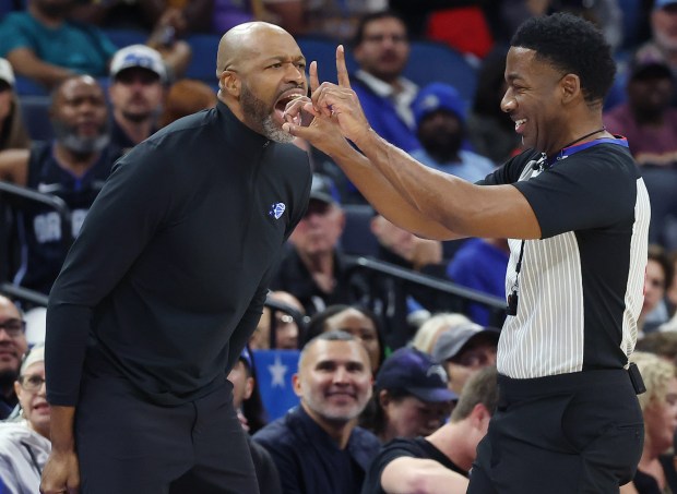 Orlando coach Jamahl Mosley yells behind game official James Williams...