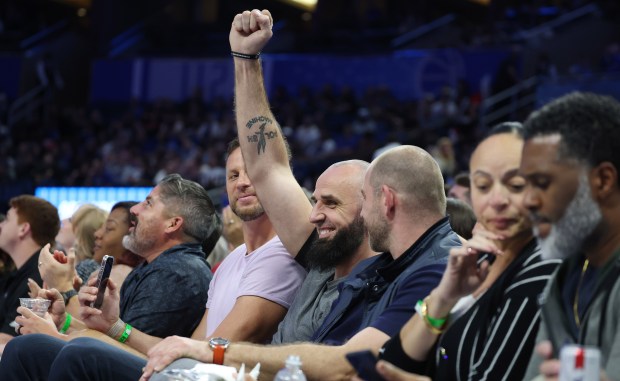 Former Orlando Magic player Marcin Gortat watches in courtside seats...