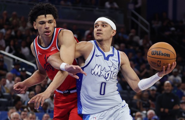 Orlando guard Anthony Black (0) is fouled by LA guard...