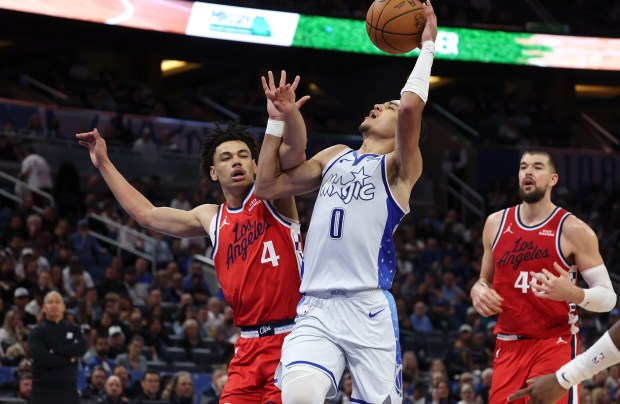 Orlando guard Anthony Black (0) is fouled by LA guard...