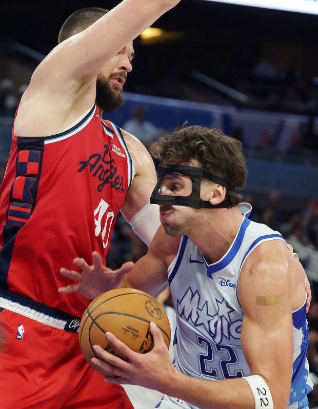 Orlando forward Franz Wagner (22) tries to drive through LA...