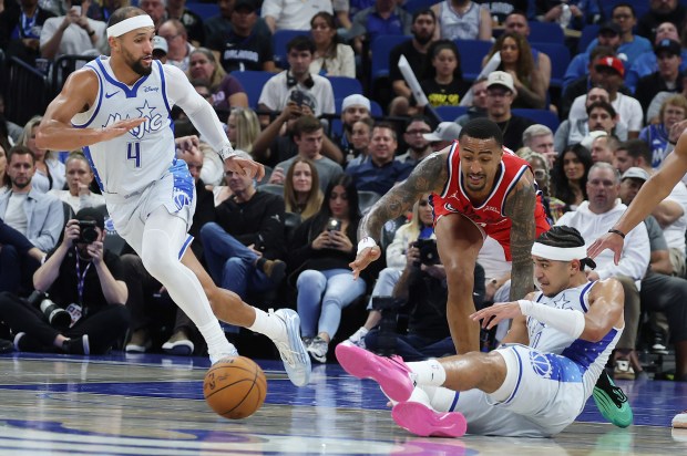 Orlando guards Jalen Suggs (4) and Anthony Black (bottom) knock...