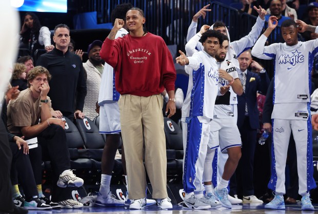 Injured Orlando forwrard Paolo Banchero (middle) and others cheer from...