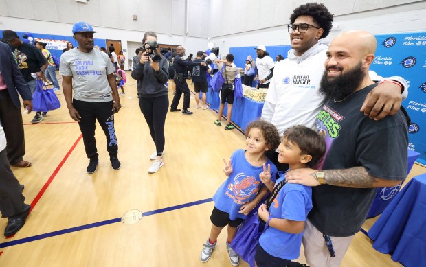 Orlando Magic guard Jase Richardson poses for photos with a...