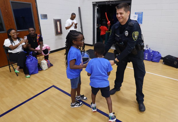 Eatonville Police Officer Colangelo plays with kids during a Thanksgiving...