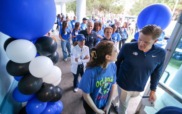 A THANKSGIVING TRADITION — Charles Freeman, right, team President of...