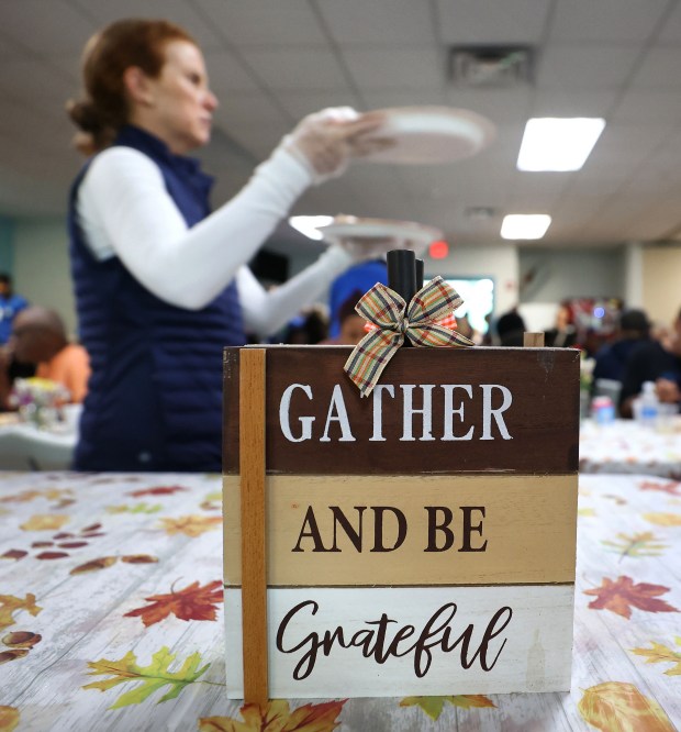 A THANKSGIVING TRADITION — A volunteer serves at the Orlando...