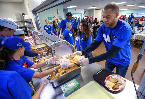 Team general manager Anthony Parker plates up to serve at the Orlando Magic 33rd Annual Thanksgiving Breakfast in partnership with the Coalition for the Homeless of Central Florida at their downtown campus on Thursday morning. (Joe Burbank/Orlando Sentinel)