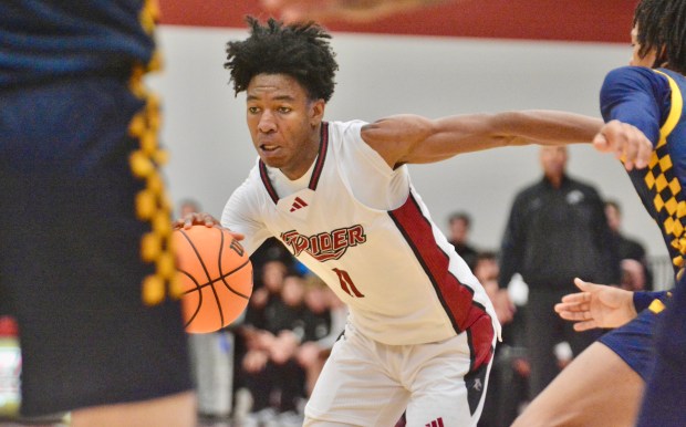Rider’s Flash Burton, 11, drives to the basket against Coppin...