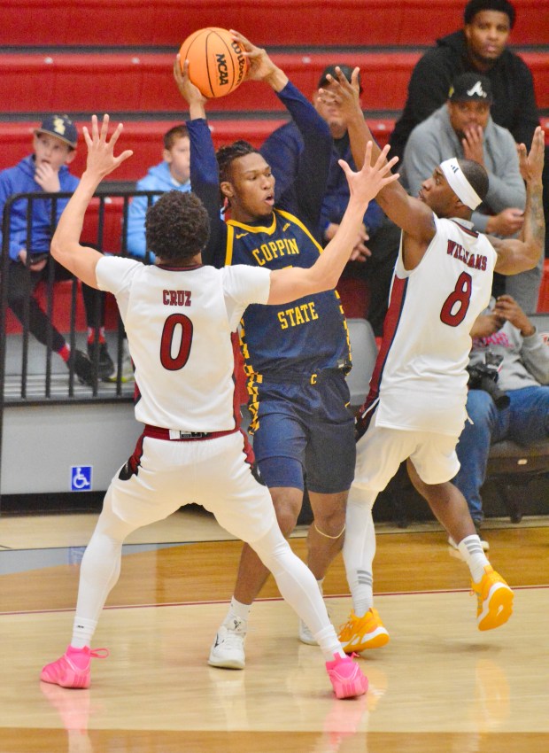 Rider’s Zion Cruz, 0, and Devean Williams, 8, defend against...