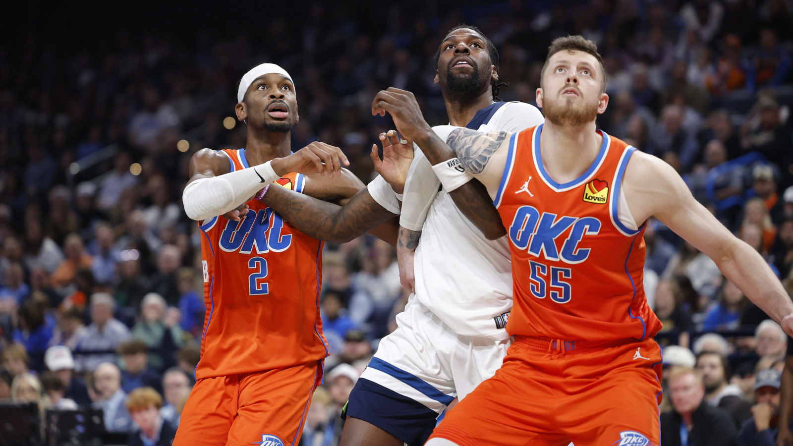Thunder guard Shai Gilgeous-Alexander (2), center Isaiah Hartenstein (55) and Minnesota Timberwolves center Naz Reid (11) react as a rebound comes down during the second half at Paycom Center