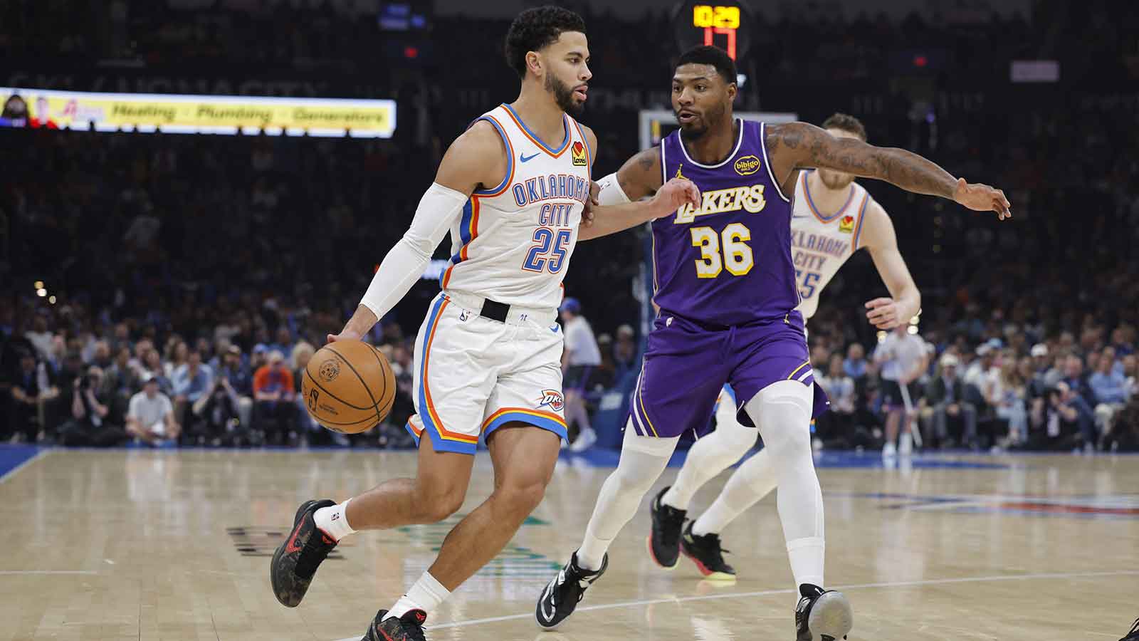 Thunder guard Ajay Mitchell (25) moves the ball around Los Angeles Lakers guard Marcus Smart (36) during the second quarter at Paycom Center