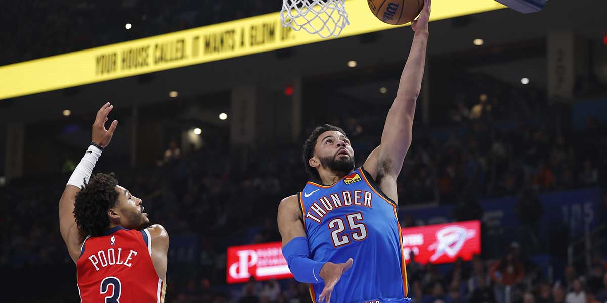 Thunder guard Ajay Mitchell (25) goes to the basket beside New Orleans Pelicans guard Jordan Poole (3) during the second quarter at Paycom Center 