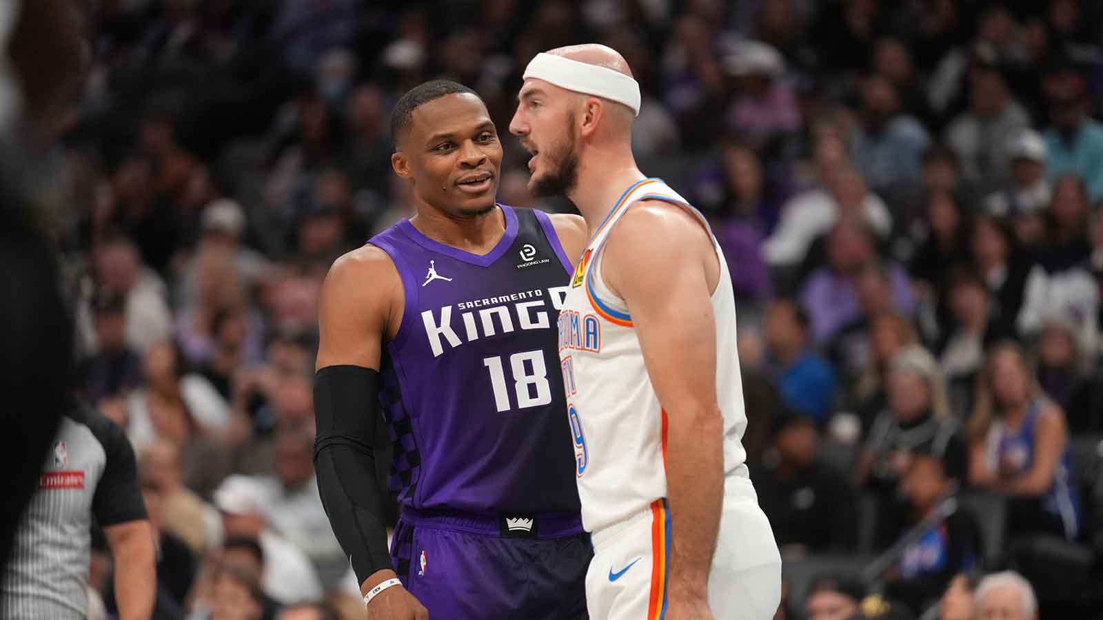 Kings guard Russell Westbrook (18) talks with Oklahoma City Thunder guard Alex Caruso (9) during a break in the action in the second quarter at the Golden 1 Center
