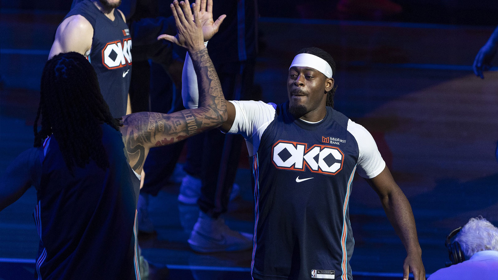 Thunder guard Luguentz Dort (5) high fives his team during introductions before the start of a game against Sacramento Kings during the first quarter at Paycom Center