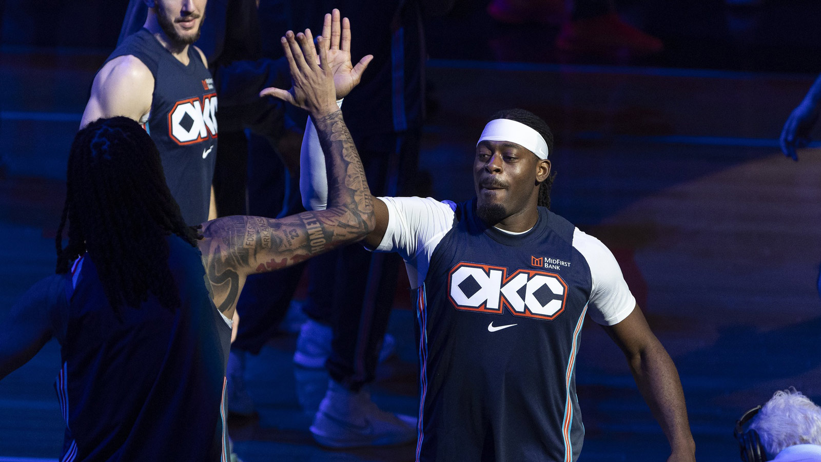 Thunder guard Luguentz Dort (5) high fives his team during introductions before the start of a game against Sacramento Kings during the first quarter at Paycom Center