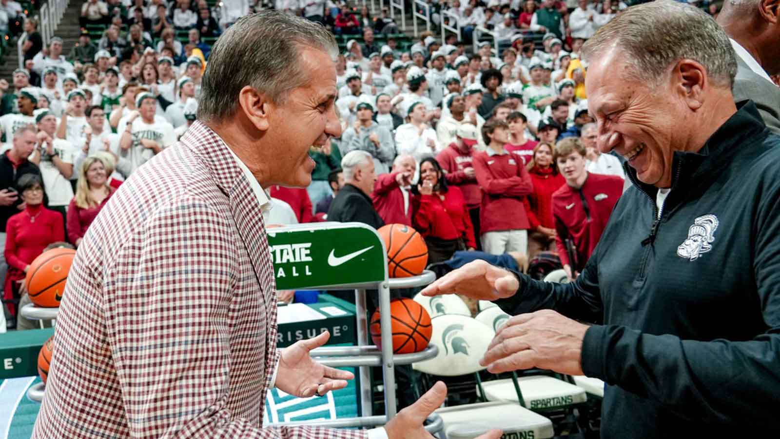 Arkansas' head coach John Calipari, left, and Michigan State's coach Tom Izzo meet before the game on Saturday, Nov. 8, 2025, at the Breslin Center in East Lansing.