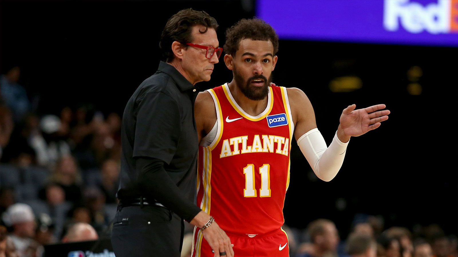 Atlanta Hawks head coach Quin Snyder (left) talks with Atlanta Hawks guard Trae Young (11) during the first quarter against the Memphis Grizzlies at FedExForum. 