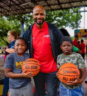 HBCU All-Star Game Travis Williams and members of the community holding pro-level basketballs in Houston, Texas.