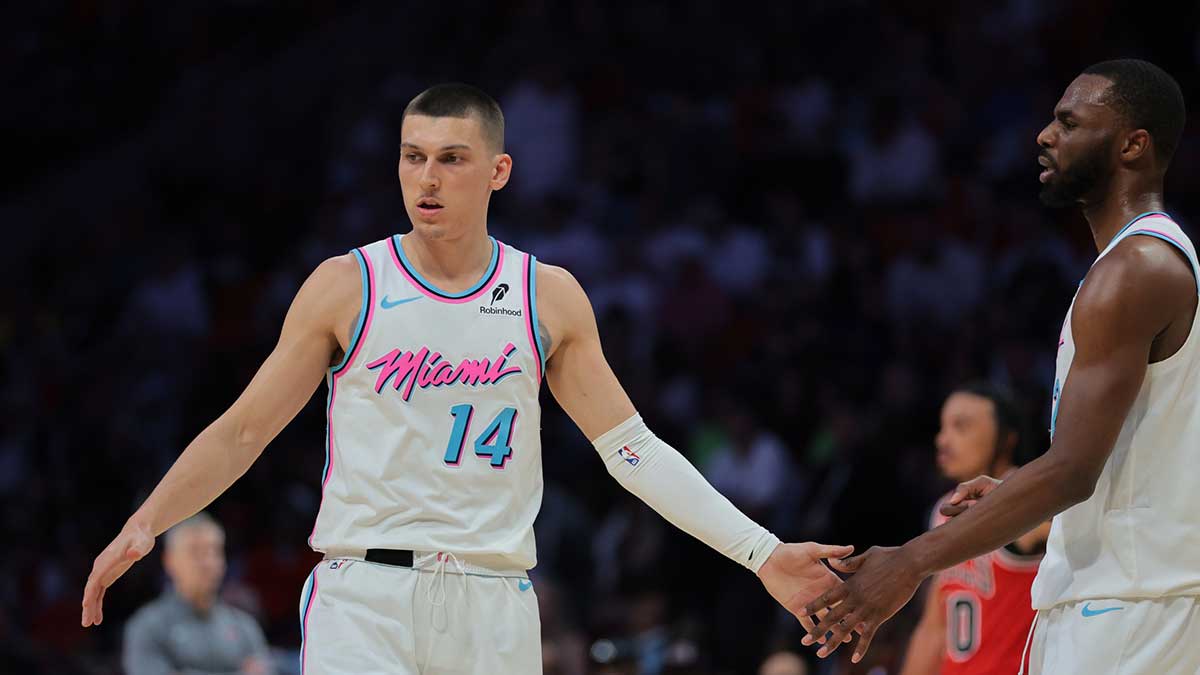 Miami Heat guard Tyler Herro (14) celebrates with forward Andrew Wiggins (22) against the Chicago Bulls during the third quarter at Kaseya Center.