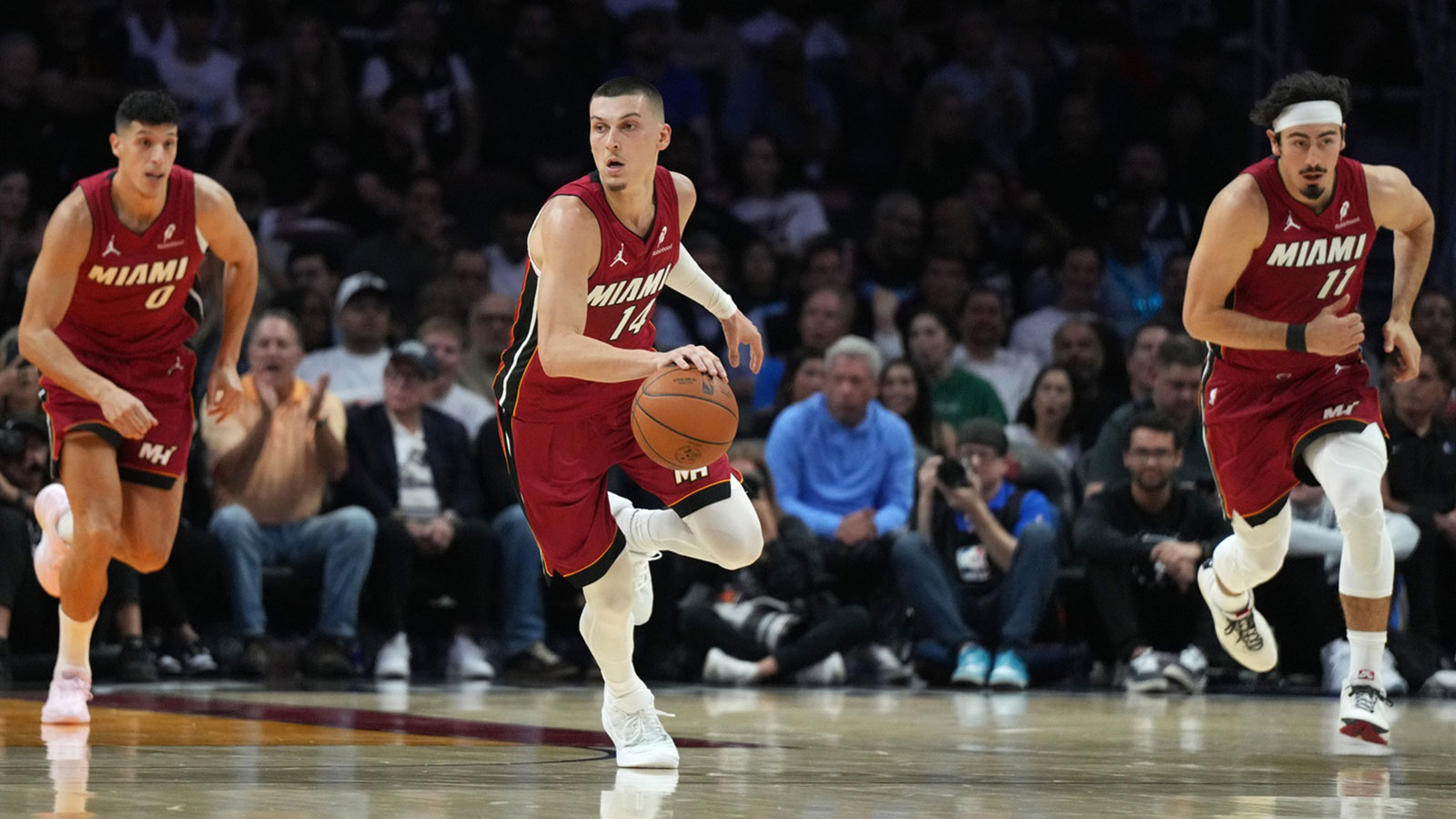 Miami Heat guard Tyler Herro (14) brings the ball up the court against the Dallas Mavericks in the first half at Kaseya Center.