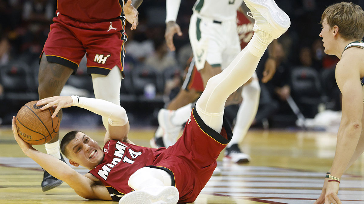 Miami Heat guard Tyler Herro (14) grabs a loose ball against the Milwaukee Bucks during the second half of an NBA Cup game at Kaseya Center.