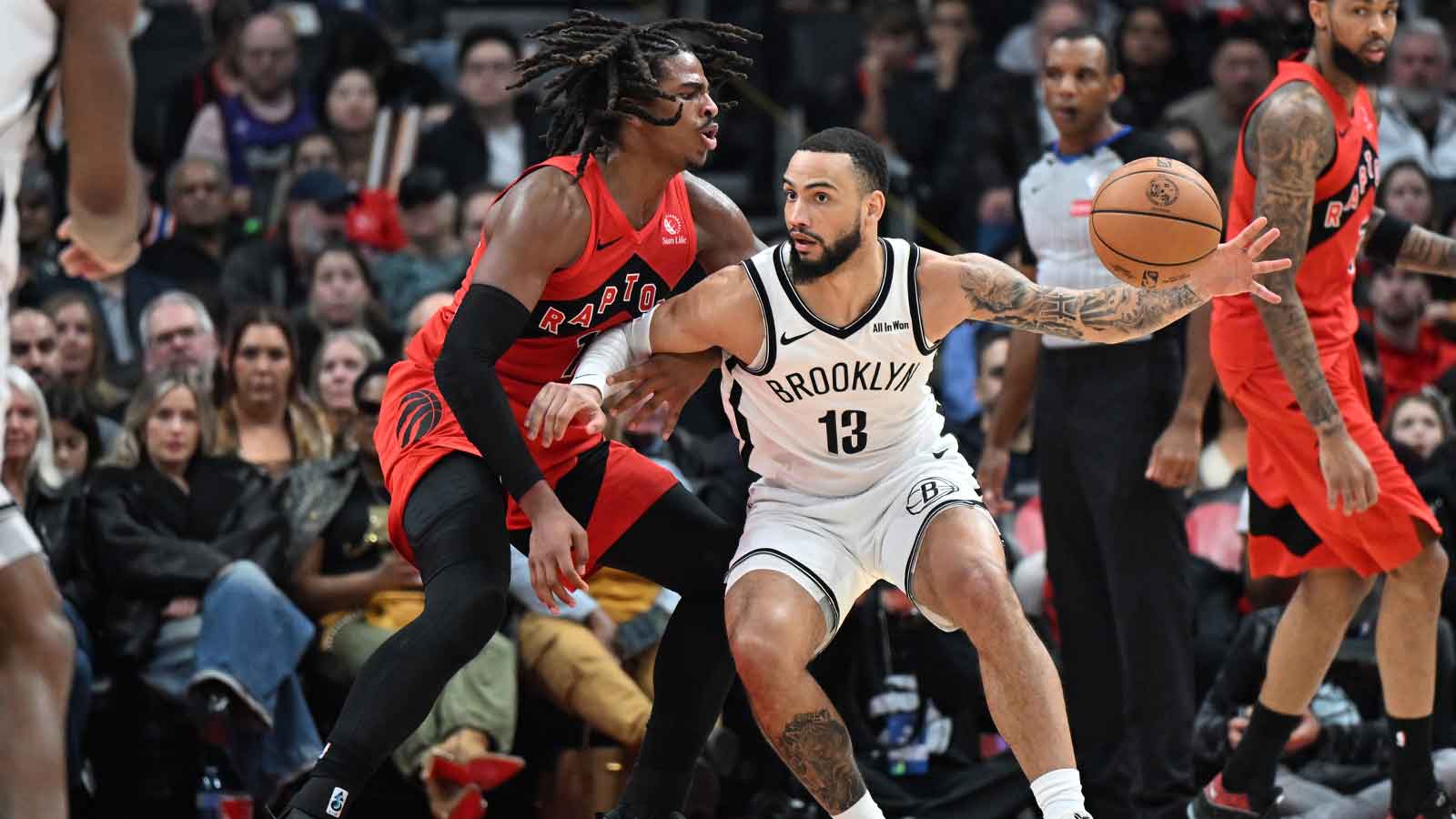 Brooklyn Nets forward Tyrese Martin (13) loses control of the ball against Toronto Raptors forward Collin Murray-Boyles (12) in the second half at Scotiabank Arena.